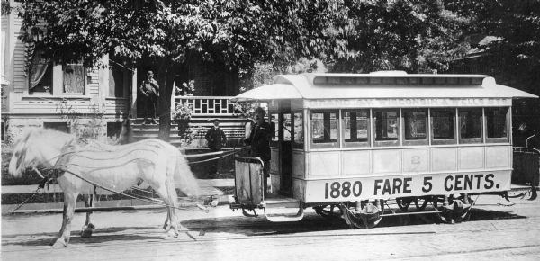Milwaukee trolley that is pulled by two horses. Original Falk caption reads, "Photos borrowed from Milwaukee County Transport for use in brochure 850801. Originals returned to County. Milwaukee streetcars."