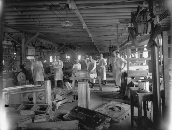 Several male employees appear to prparing molds for gears. Original Falk caption reads, "Centennial historical photos of old negative which could be lost forever. Probable dates prior to World War One."