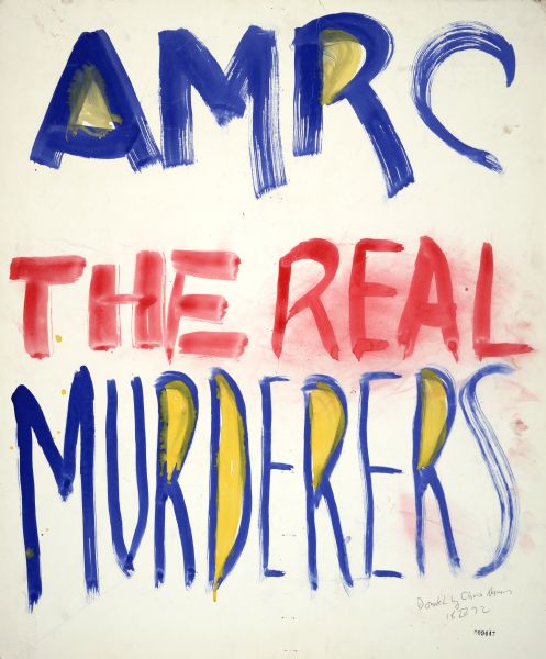 Sign board used for protest in the wake of the Sterling Hall bombing that reads, "AMRC The Real Murderers,"in watercolor.