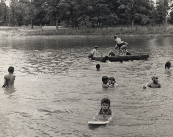Children swimming in a lake as part of Highlander Folk School's Koinonia Children's Camp.