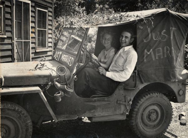 Tom Ludwig and Vida Cox [Ludwig], a neighbor of Highlander Folk School, sitting in a Jeep together after having been married. The couple met while at the school.