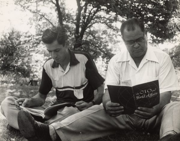 Two CIO students reading books outside at Highlander Folk School.  One book is titled, "The CIO and World Affairs".