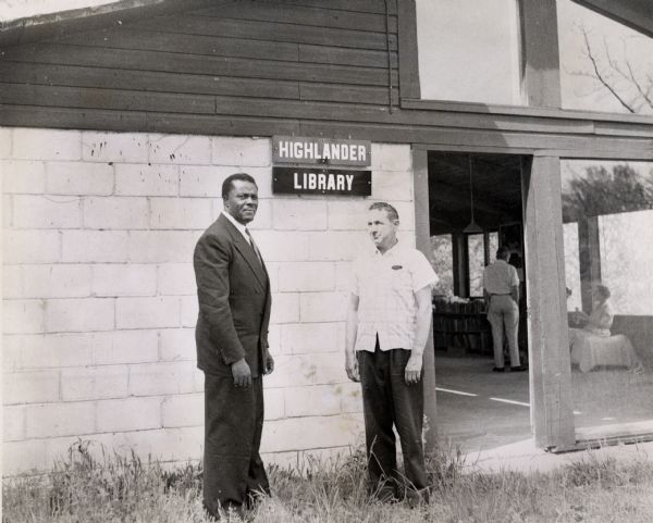 Myles Horton (right), standing in front of the library building with unidentified individual, at Highlander Folk School.