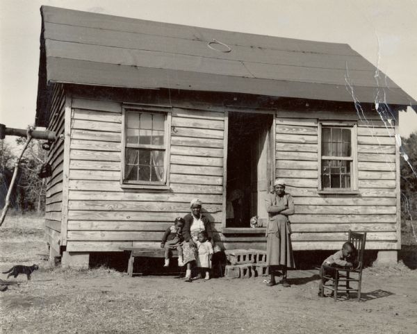 A family from Sea Island that participated in the Citizenship Group. Cats can be seen to the left and in the doorway.