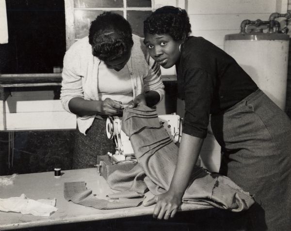 Bernice Williams working with a younger CIO member on a sewing machine at the South Carolina Citizenship group.