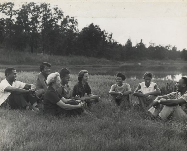 Civil rights group meeting in field at Highlander Lake.  Fifth from the left, Charlotte Meacham, American Friends Service Committee, former Highlander student.