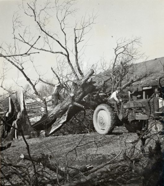 Horton House at Highlander after a tornado.  A tractor is pulling away a fallen tree.