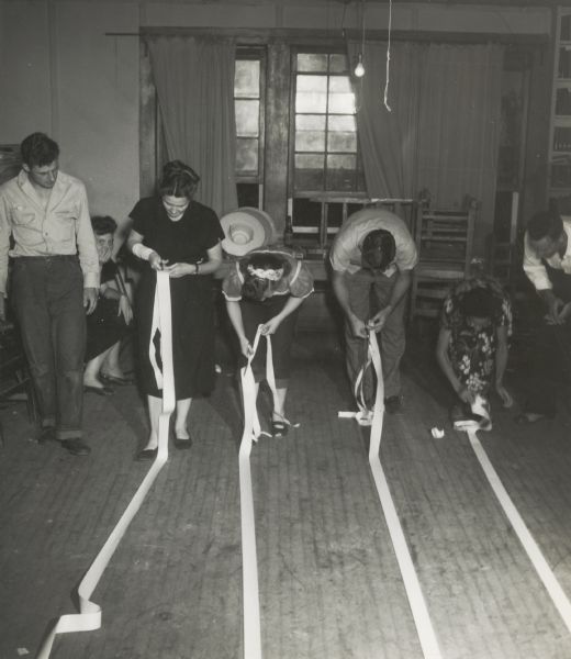 Participants in a CIO workshop at Highlander Folk School cut long ribbons of paper.  Extreme left, J.D. Marlowe, a community member.