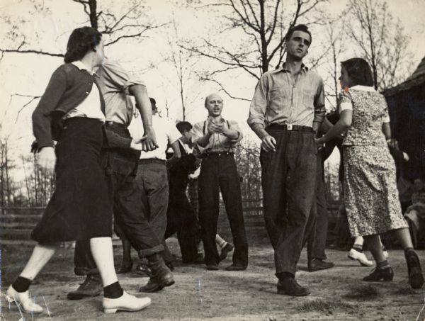 Early thirties square dancing at Highlander Folk School, led by Ralph Tefferteller. Henry Thomas is the caller featured in the center of the yard.