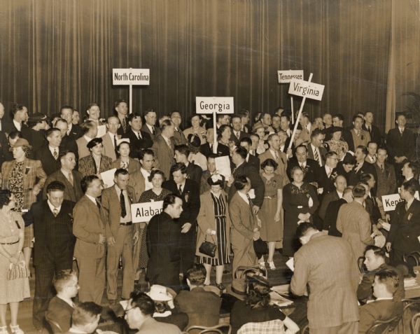 Early CIO convention-organizers and union officials at a textile workers [?] convention.