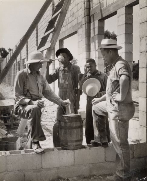 Workers taking a break from building Farmers Union coop.