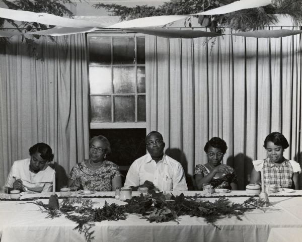 Four women and a man eating at a table at a Civil Rights banquet at Highlander Folk School. Septima Clark, second from left.