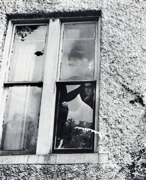 Myles Horton inspecting a group of broken windows at Highlander Folk School.