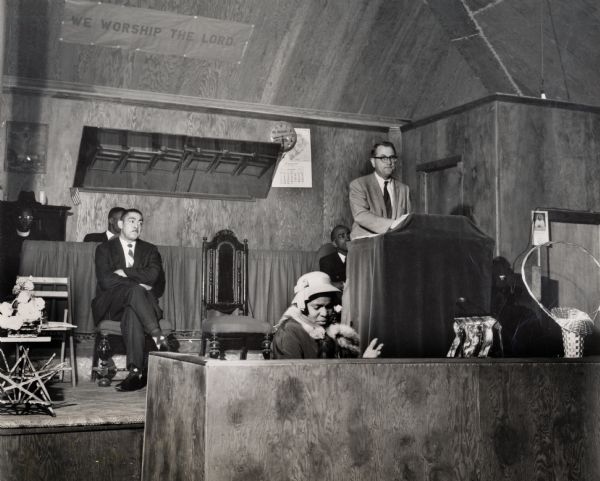 Charleston civil rights mass meeting, Myles Horton speaking. Joe Brown is sitting to the left of the podium, who later joined the South Carolina legislature.