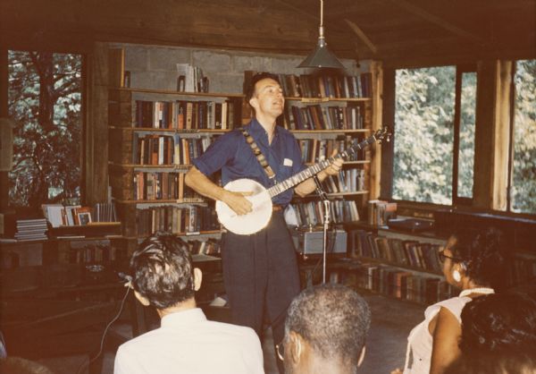 Pete Seeger playing the 5-string banjo at the 25th Anniversary of Highlander Folk School in the Library building.