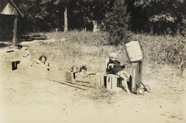 A group of children, part of Highlander Folk School's nursery, making a train with wooden crates.