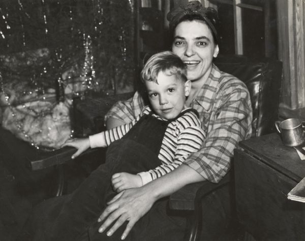 Zilphia Horton, with her son, Thorsten, sitting in her lap.  A Christmas tree, covered with tinsel, can be seen in the background.