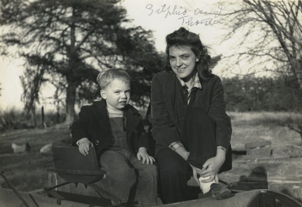 Zilphia Horton with son, Thorsten, sitting on the bench of a carriage.