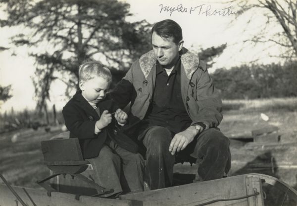 Myles Horton with son, Thorsten, sitting on the bench of a carriage.