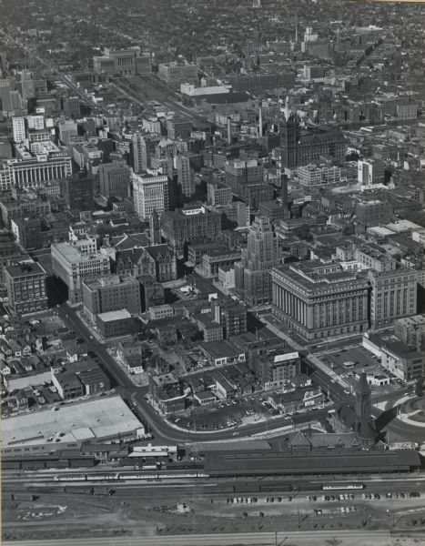 Aerial view of downtown, including railroad tracks in foreground.