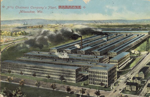 Elevated view of factory with yellow walls and blue roofs. Lake and trains in background, with a tree-lined boulevard in the foreground. Caption reads: "Allis Chalmers Company's Plant, Milwaukee, Wis."