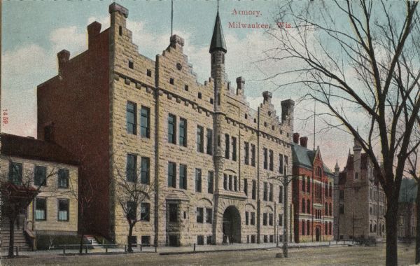 View across street toward the Armory, with the police station on the right, and private residence on the left. Caption reads: "Armory, Milwaukee, Wis."