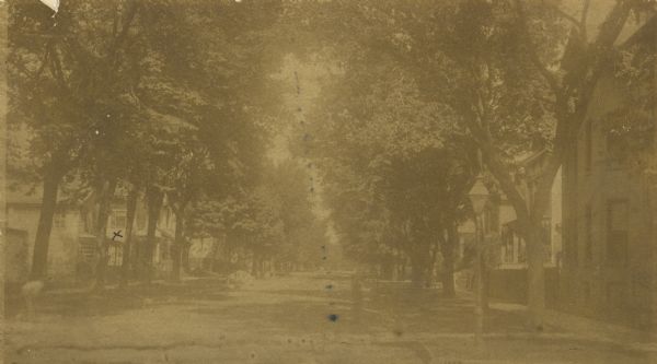 View of Biddle Street.  The 'x' marks the home of Mr. Brigham.  The road is tree-lined, with homes behind the trees.  "With cross on it, just under the south window in hall, where we used to sit."-Brigham.