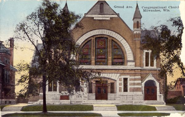 Color postcard view from street toward the front of the church on Grand Avenue. There is a large stained glass window in the arch above the entrance. Captions read: "Grand Ave." and "Congregational Church, Milwaukee, Wis."