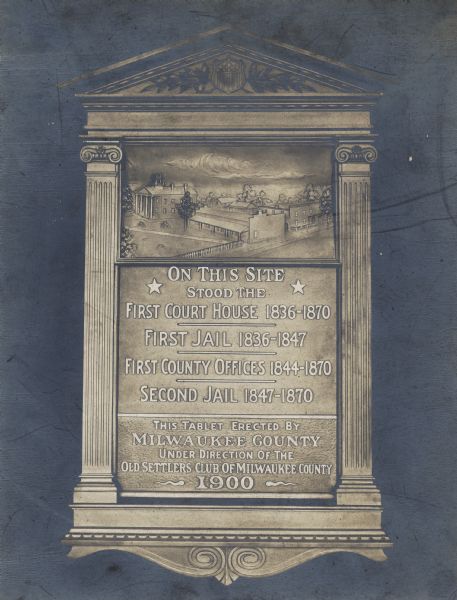 Plaque marking the site of the first Court House, first and second jails, and the first County Offices.  Erected by Milwaukee County, the plaque has classical details: two mini fluted columns with doric capitals on the sides, details on the bottoms, and a shield with olive branches on the lintel.  Above the words is a relief of the buildings mentioned.