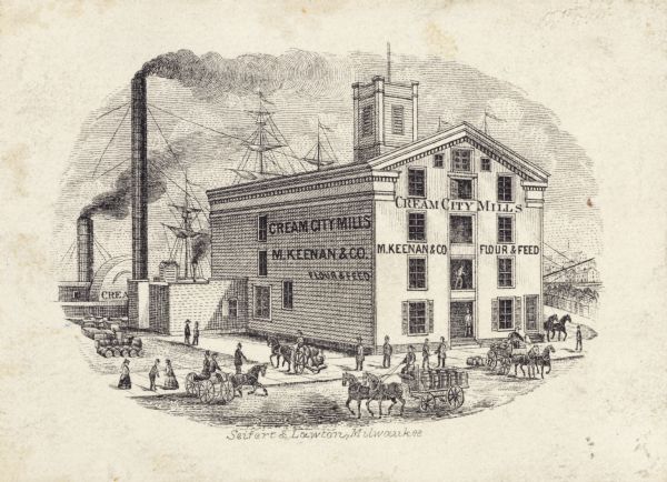 M. Keenan & Company, flour and feed mill. Small print of mill on the water front. River is behind the building with a steamboat and a ship. A tall smokestack is to the left of the building. On the road in front and on the side are several horse-drawn carts and various people along the sidewalk.