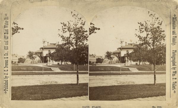 Stereograph; view of a building from across a road.  Building has a fountain to the left.