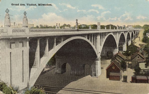 View toward viaduct, with railroad tracks and houses below. Caption reads: "Grand Ave. Viaduct, Milwaukee."