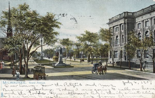 Slightly elevated view of Grand Avenue. Several horse-drawn vehicles are on the road and pedestrians are along the sidewalks. Caption reads: "Milwaukee. Grand Avenue."