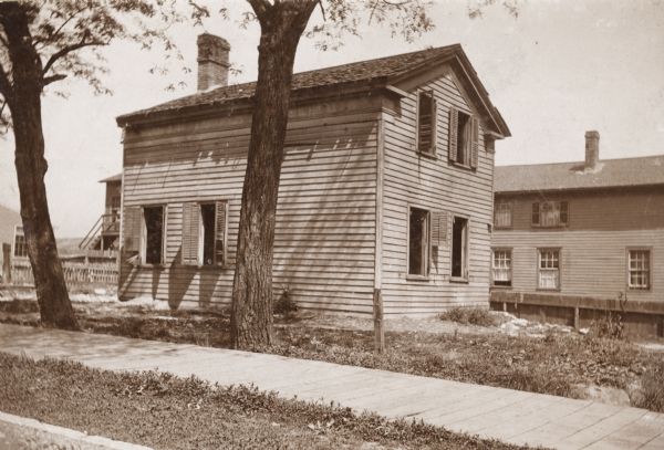 Built 1836-37, on the northwest corner of Florida and Greenbush. A manuscript note on the reverse of the photograph called it the "oldest school under destruction <i>[sic]</i>.," but research revealed no mention that this had been used as a school. However, in the early period of Milwaukee history, many schools rented various homes, church basements, etc., to hold classes until they could afford to build; this house may well have been so used at some time.