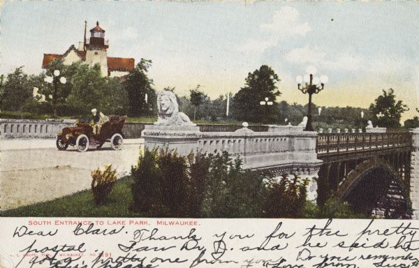 South entrance; an open car with two people is crossing the bridge. Stone lions flank the bridge on each corner. A lighthouse is in the background. Caption reads: "South Entrance to Lake Park, Milwaukee."