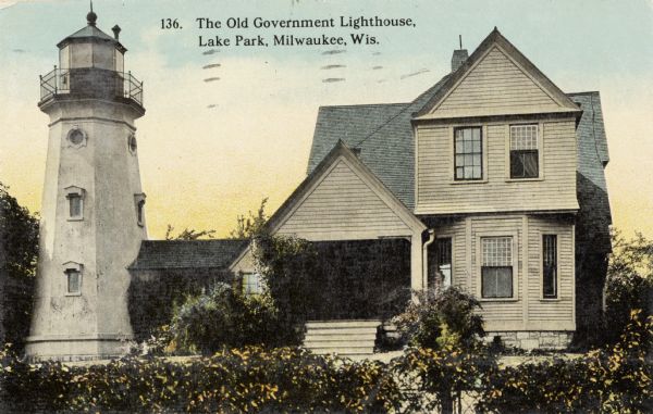 Old Government Lighthouse at Lake Park. The lighthouse is connected to a house, surrounded by shrubs. Caption reads: "The Old Government Lighthouse, Lake Park, Milwaukee, Wis."