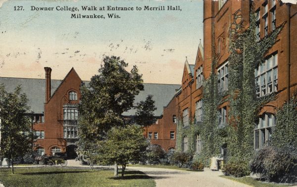 Merrill Hall; front walk at entrance. A horse and carriage are parked at the entrance. Vines are growing up the side of the building on the right. Caption reads: "Downer College, Walk at Entrance to Merrill Hall, Milwaukee, Wis."