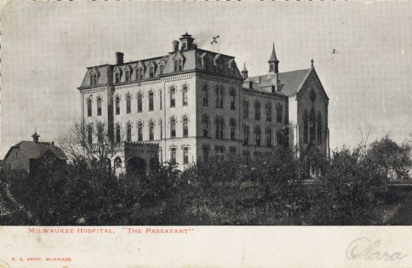 Milwaukee Passavant Hospital building behind a line of trees in the foreground. Caption reads: "Milwaukee Hospital,'The Passavant.'"