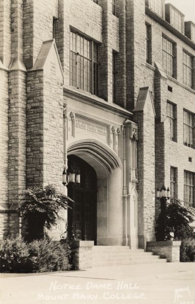 Front entrance to Notre Dame Hall; taken at an angle.  The name of the hall is above the arched doorway.
