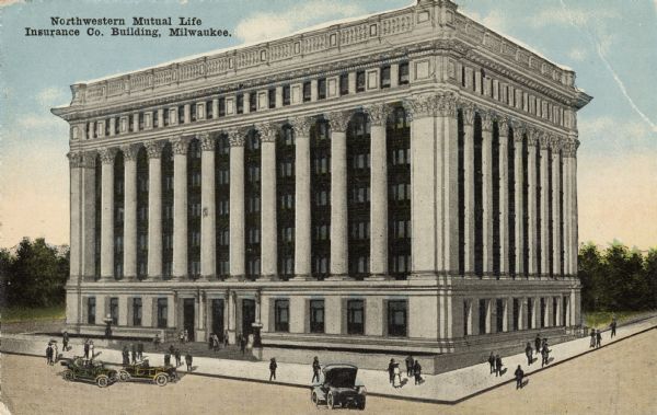 Elevated view toward the front entrance of the building. Pedestrians are on the sidewalk, and three motorcars are on the road in front of the entrance. Caption reads: "Northwestern Mutual Life Insurance Company Building,Milwaukee."