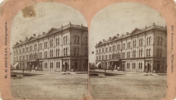 Stereograph. Located on Oneida Street, the opera house is three stories tall, and located across the street from a pharmacy (the Rx sign is hanging above the street on the left side of the picture).