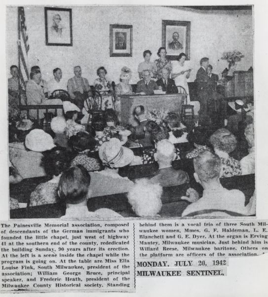 Newspaper clipping giving information about the chapel. Above the article is a photograph of a meeting in progress.