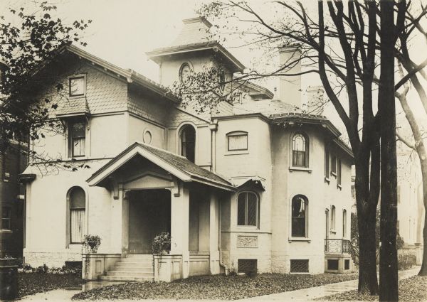 E.T. Mix, architect. 1 Waverly Place, built 1872. Three-quarter view of the front and right side of the house. A sidewalk and trees are on the right, with another house in the background.
