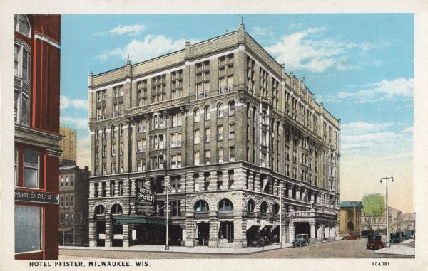 Slightly elevated view toward the hotel on the corner of Wisconsin Avenue and Jefferson Street. Cars are parked on the road on the right. Caption reads: "Hotel Pfister, Milwaukee, Wis."