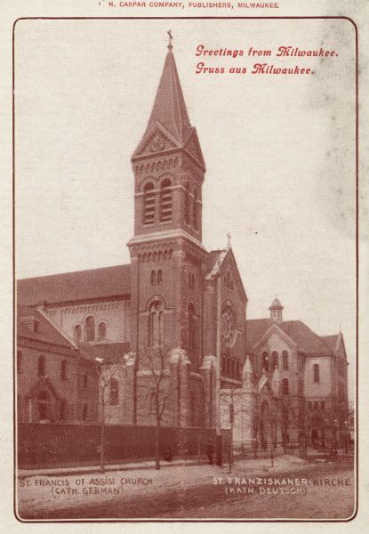 N. Fourth Street. Bell tower with clock to the left of the main entrance. Additional buildings are on either side of the main church. Identified on left is: "St. Francis of Assisi Church (Cath. German) and on the right: "St. Franziskaner • Kirche (Kath. Deutsch)." Caption at top reads: "Greetings from Milwaukee. Gruss aus Milwaukee."