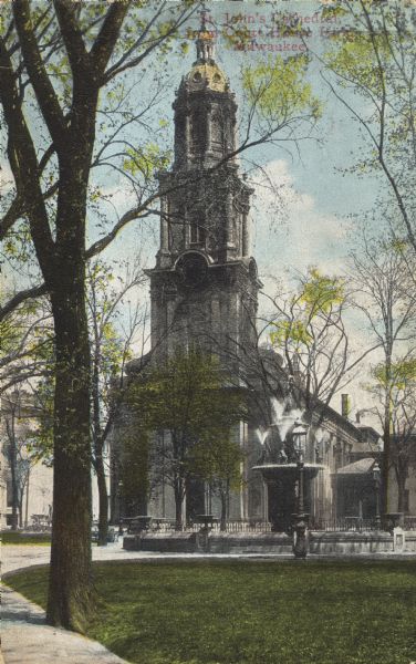 A fountain and trees in Courthouse Square (now Cathedral Square) in front of the church. Caption reads: "St. John's Cathedral from Court House Park, Milwaukee."