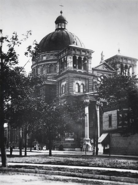 A classical Romanesque basilica. Facing southwest from Chase Avenue, just south of Lincoln Avenue.  Pedestrians are near the entrance.