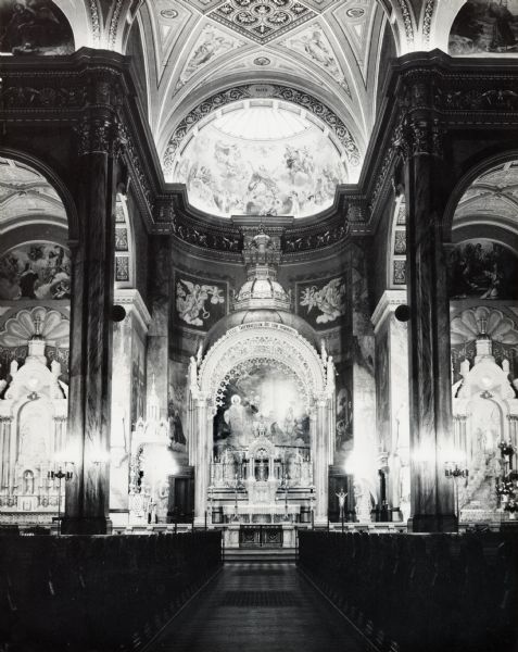 Interior, with main altar in the apse. Ornate interior, decorated with sculpture and painting.