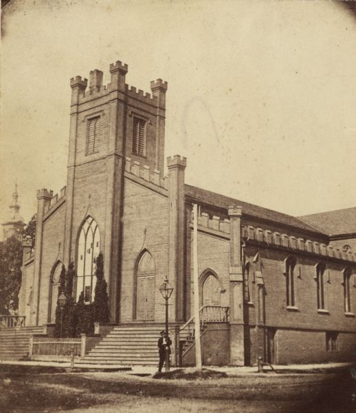 On the site of the Layton art gallery, on the northeast corner of East Mason and North Jefferson Streets.  A man is standing at a corner light post.