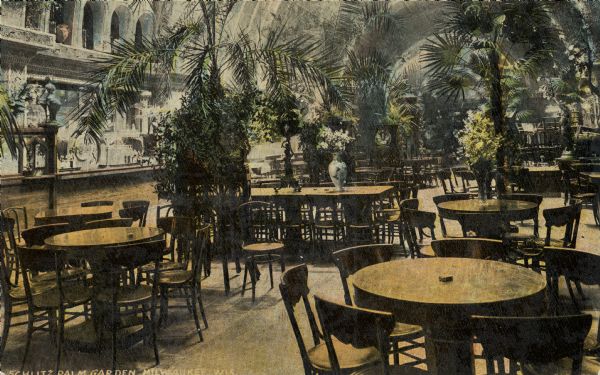 Restaurant interior. The bar is on the left, with the arched ceiling overhead. Palm trees decorate the spaces between the tables. Located on N. 3rd Street, south of W. Wisconsin Avenue, the Schlitz Palm Garden opened on July 3, 1886 and was one of the most popular and opulent in Milwaukee. Caption reads: "Schlitz Palm Garden, Milwaukee, Wis."